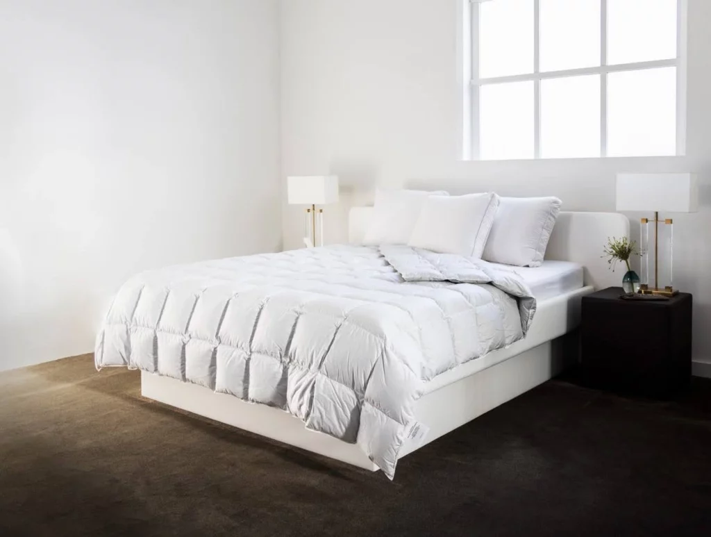 Luxury white mattress, duvet, and pillows.